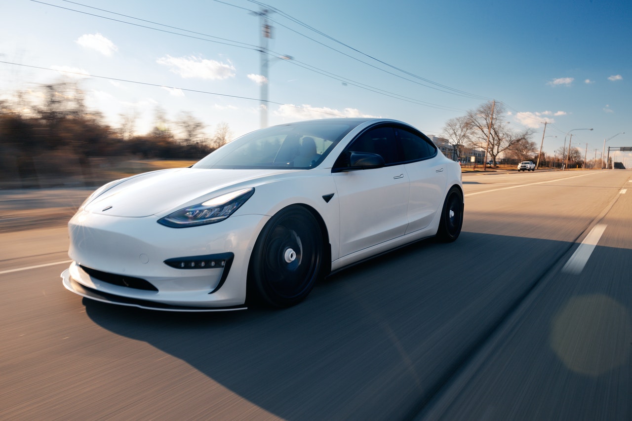 White-Driving-Tesla