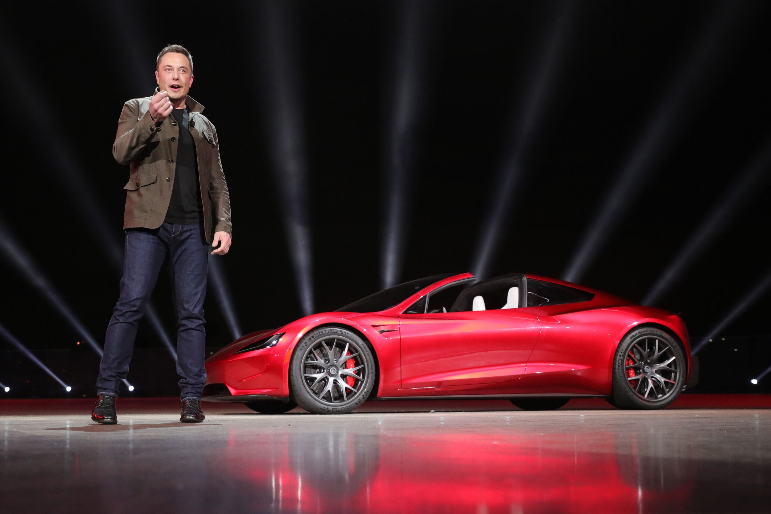 Red Tesla Roadster and Elon Musk.